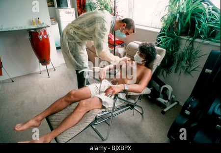 Paris, France - Hospitalization at Home, Male Nurse Installing a Catheter at a Patient's House. Stock Photo