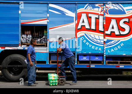 Two men chatting while unloading soft drinks from Atlas Beer delivery truck in market, Penonome, Cocle Province, Panama Stock Photo