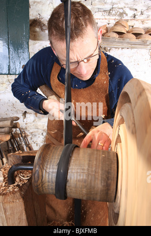 Woodturner Robin Wood and bowls in his workshop at Edale in the Peck District using a foot powered pole lathe. Stock Photo