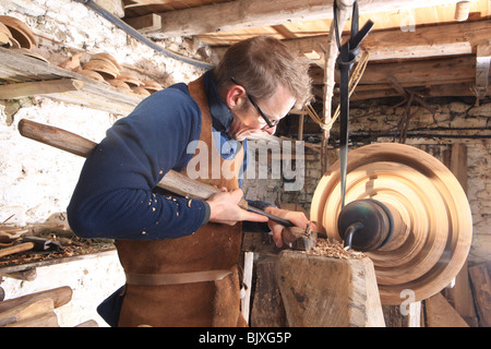 Woodturner Robin Wood and bowls in his workshop at Edale in the Peck District using a foot powered pole lathe. Stock Photo