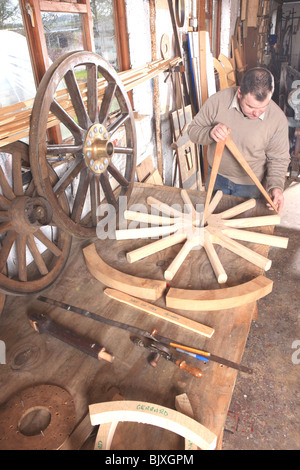 Traditional wheelwright Greg Rowlands working on a new wheel using  callipers his workshop at Colyton Devon Stock Photo