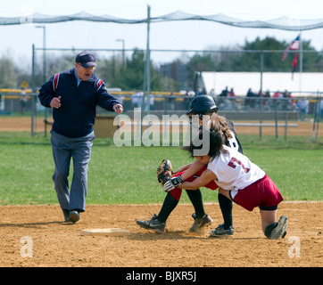 Girls high school softball game. Runner tagged out at second. Umpire calling the play an out. Stock Photo