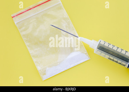 Powdered drugs wrap and syringe for injecting. Stock Photo