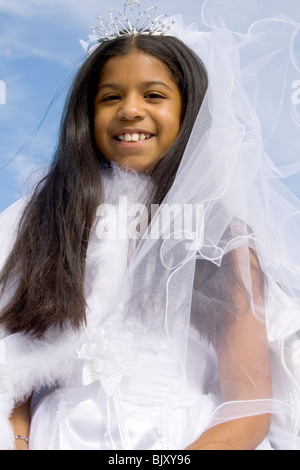 Young Hispanic princess age 11 in white gown wearing a crown. Cinco de Mayo Fiesta St Paul Minnesota USA Stock Photo
