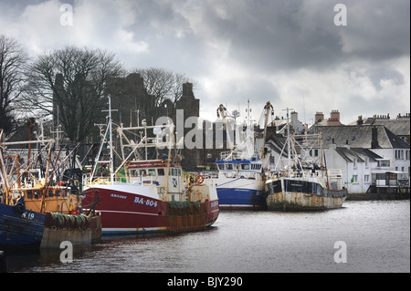 Scallop fishing boats in Kirkcudbright harbour berthed under the shadow of McLellan's castle Stock Photo