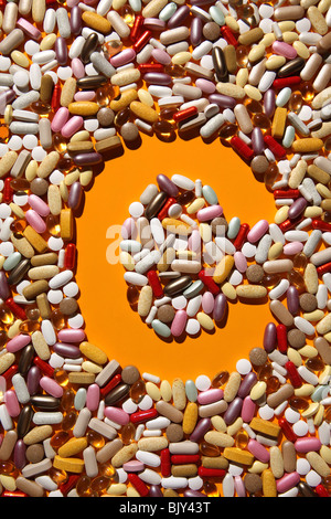 The shaped of the letter C formed with many colorful pills, tablets and capsules Stock Photo