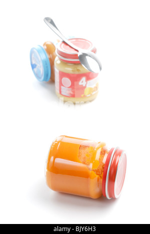 Baby food in glass jars with spoon, selective focus Stock Photo