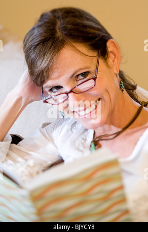 Close-up portrait of middle-aged woman holding book Stock Photo