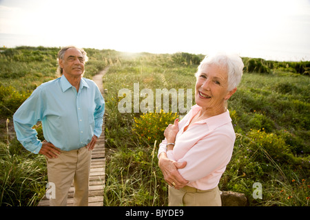 Portrait of smiling senior couple standing outdoors Stock Photo