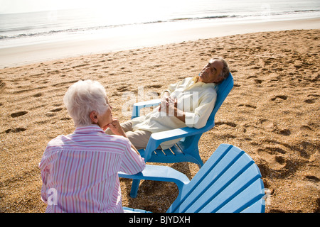 Senior couple snoozing in chairs at the beach Stock Photo - Alamy