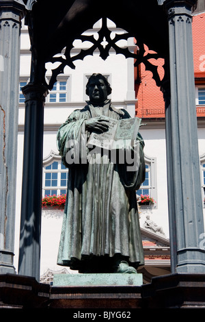 Statue of Martin Luther with 39 Theses in hand in town/city of Wittenberg Saxony Germany Stock Photo