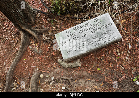 abortion grave marker in garden of church Stock Photo