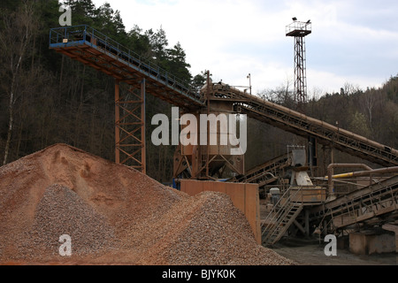 Stone quarry with silos, conveyor belts and piles of stones. Stock Photo