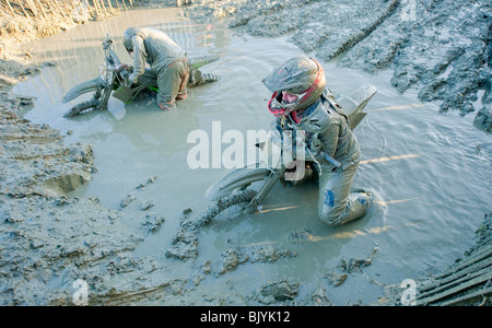 Motocross bike riders stuck in deep mud Stock Photo