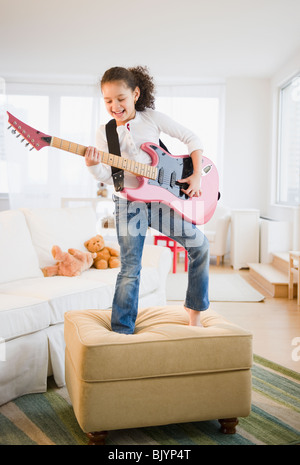 Hispanic girl playing electric guitar Stock Photo - Alamy