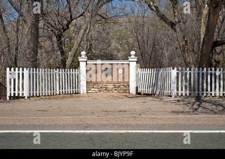 A white picket fence and adobe wall marks 'Billy the Kid's' Lincoln, New Mexico Historic District in Lincoln, New Mexico. Stock Photo