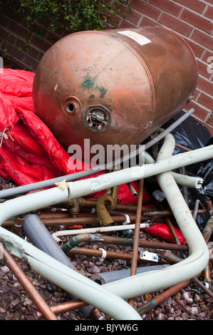 Scrap pipes and hot water cylinder from central heating boiler scrappage Stock Photo
