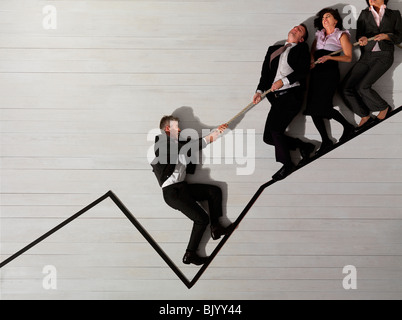 Business people pulling each other Stock Photo