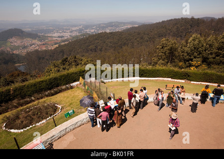 India, Tamil Nadu, Udhagamandalam (Ooty), Doddabetta Peak viewing area, Indian tourists enjoying view over town Stock Photo