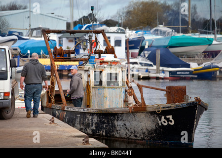 fisherman preparing a stern-trawler / shellfish dredger for inshore/coastal work Stock Photo