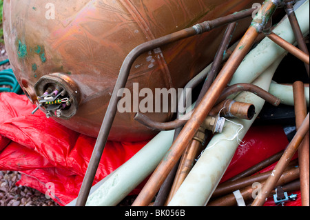 Scrap pipes and hot water cylinder from central heating boiler scrappage Stock Photo
