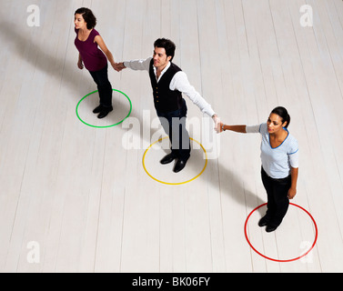 Man and women holding hands in circles Stock Photo