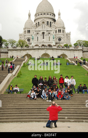 School group of teenagers posing for group shot in front of Sacre Coeur Paris Stock Photo