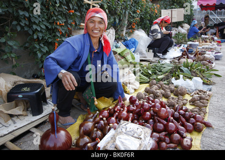 An Akha woman sells agricultural products in Mae Salong, Thailand Stock Photo