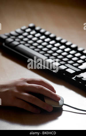 Childs hand operating a computer mouse. Stock Photo