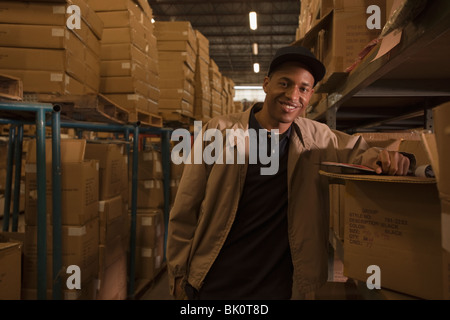 Black man working in warehouse Stock Photo