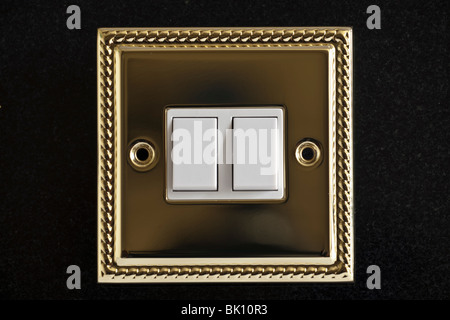 Double gold plated electric light switch Stock Photo