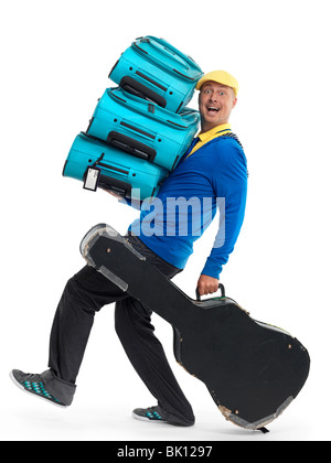 Smiling young man carrying a load of luggage. Isolated on white background. Stock Photo