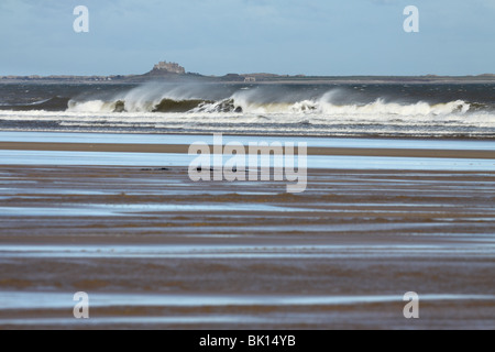 The view towards Lindisfarne from the beach at Bamburgh, Northumberland, North East England Stock Photo