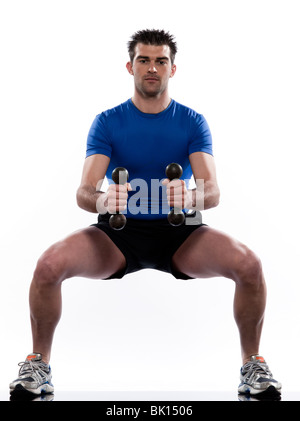 man doing workout squats weight training crouching on studio white isolated background Stock Photo