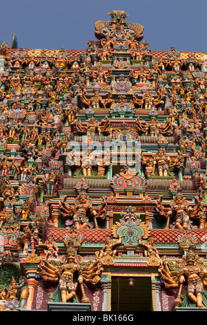 India, Tamil Nadu, Madurai, Sri Meenakshi Temple, newly restored west gopuram, crammed with deities Stock Photo