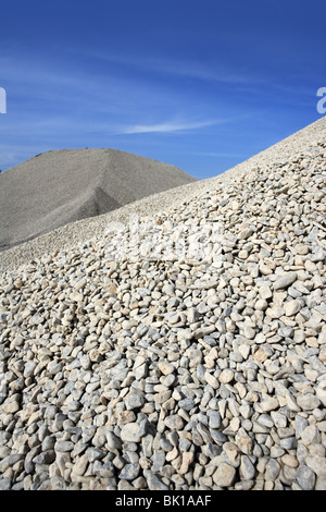 gravel gray mound quarry stock blue sky rolling stones Stock Photo