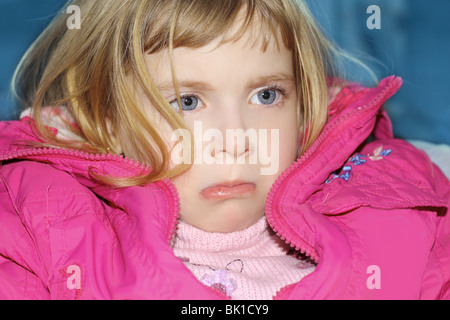sad gesture blond little girl portrait pink coat Stock Photo