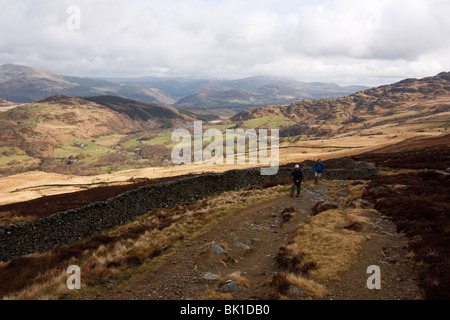 Walkers on the Pony Path ascent of Cadair Idris, with views back towards Dolgellau Stock Photo