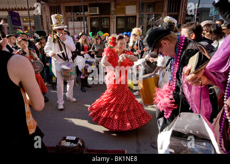 Woman in red dress dancing in French Quarter, Mardi Gras, New Orleans, Louisiana, USA. Stock Photo