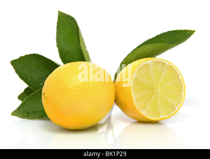 Whole and sliced organic lemons with leaves on white background Stock Photo