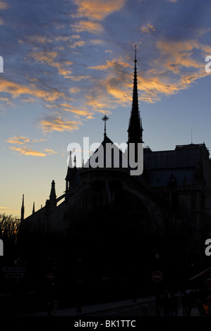 Sunset above the Notre Dame de Paris cathedral, black silhouette on a dusk sky Stock Photo