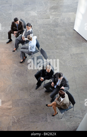 Two groups of business people discussing Stock Photo