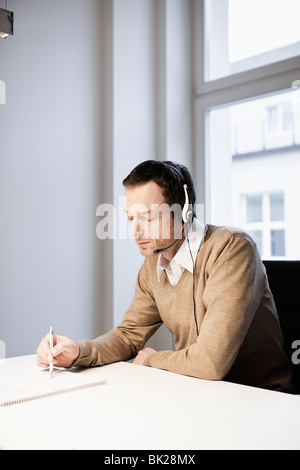 Man with headset in office Stock Photo