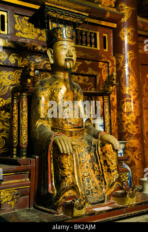 Interior with statue of Emperor Dinh Tien Hoang in the Dinh Tien Hoang Temple in the ancient citadel of Hoa Lu in Vietnam Stock Photo