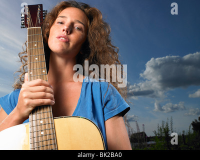 Woman holding her guitar Stock Photo