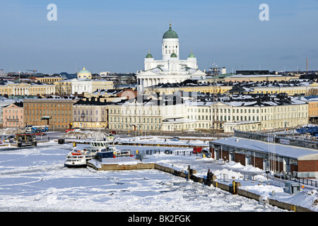 Ice covered Helsinki Harbour with Suomenlinna II berthed in the foreground and Helsinki Lutheran Cathedral raising up behind. Stock Photo