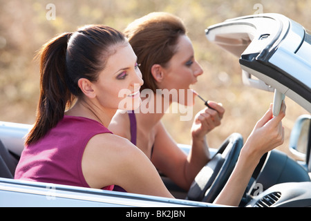 Women doing their make up in a car Stock Photo