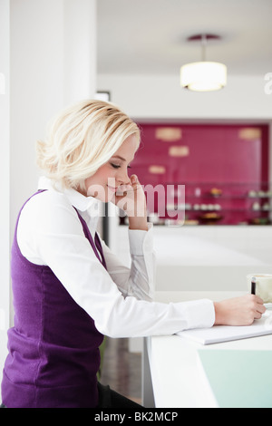 Business woman writing in a cafe Stock Photo - Alamy