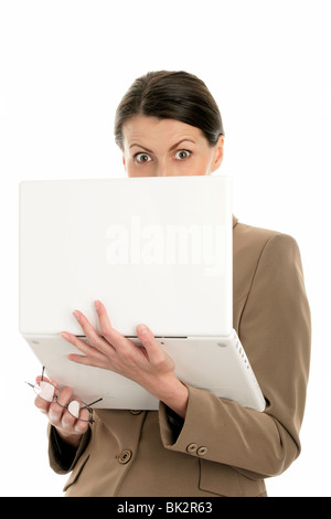 Portrait of mature scared businesswoman using laptop isolated on white background Stock Photo