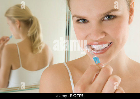 Female beauty brushing teeth Stock Photo